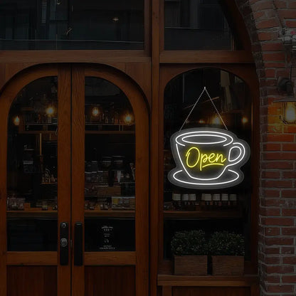yellow coffee open neon sign hanging on a window