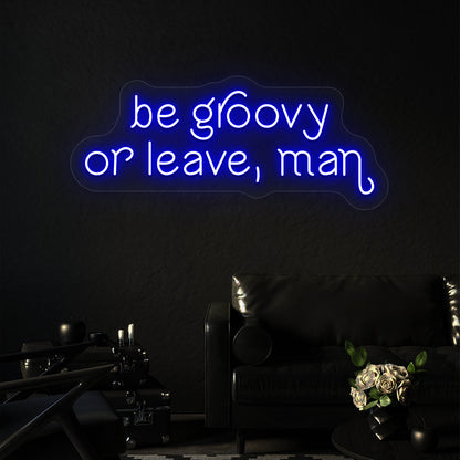 blue be groovy or leave, man vintage neon sign mounted on a wall