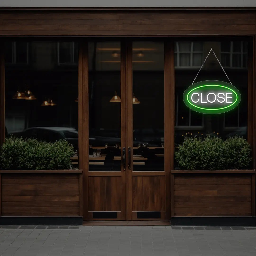 green oval close neon sign hanging on a window