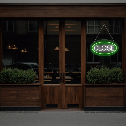 green oval close neon sign hanging on a window