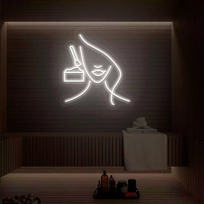 White Facial Retreat neon sign glowing on a wooden wall