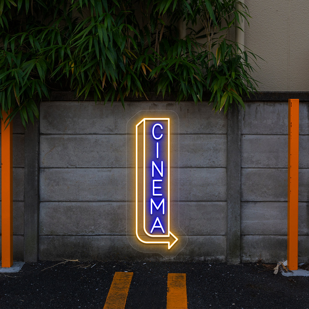 blue and orange midnight cinema vintage neon sign mounted on a wall