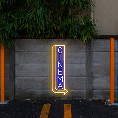 blue and orange midnight cinema vintage neon sign mounted on a wall
