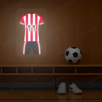 Red and white striped football jersey neon artwork with number 11 glowing on a wooden wall