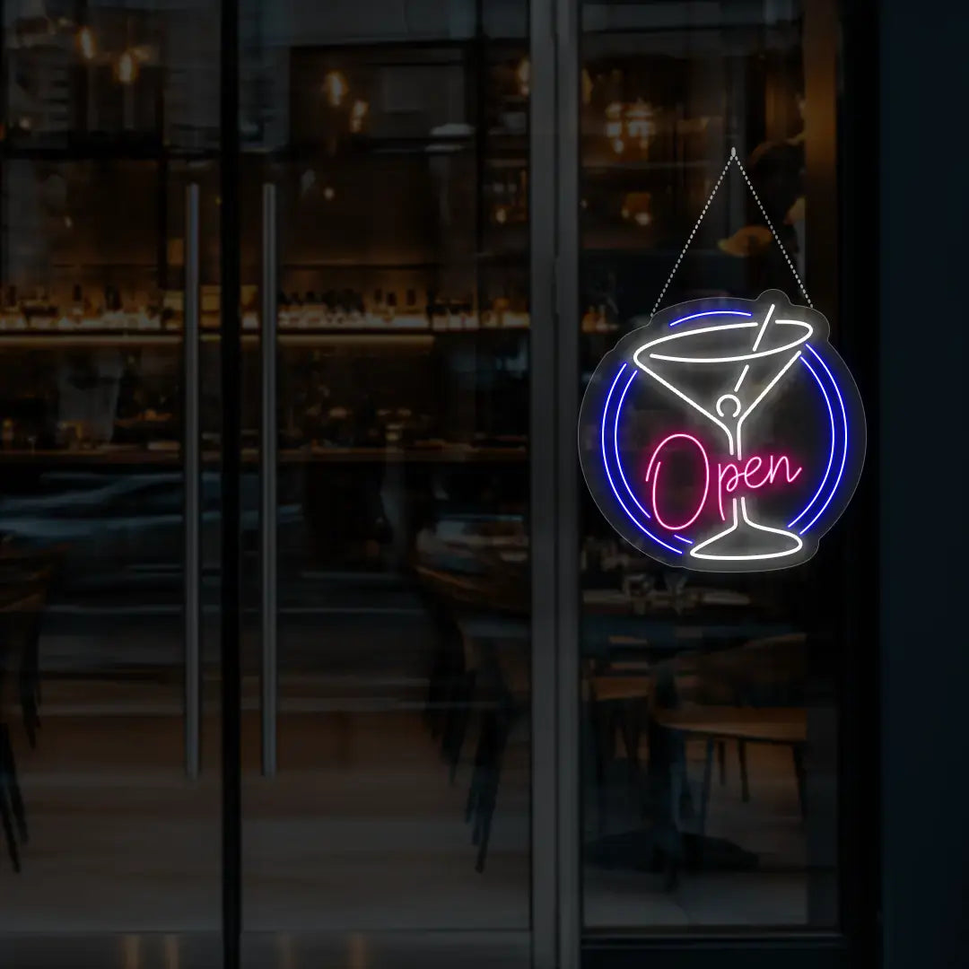 pink cocktail open neon sign hanging on a window