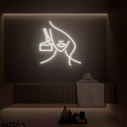 Warm white Facial Retreat neon sign glowing on a wooden wall