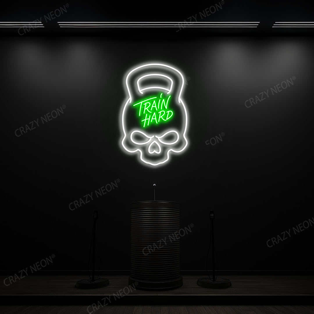 green and white train hard kettlebell neon sign mounted on a wall