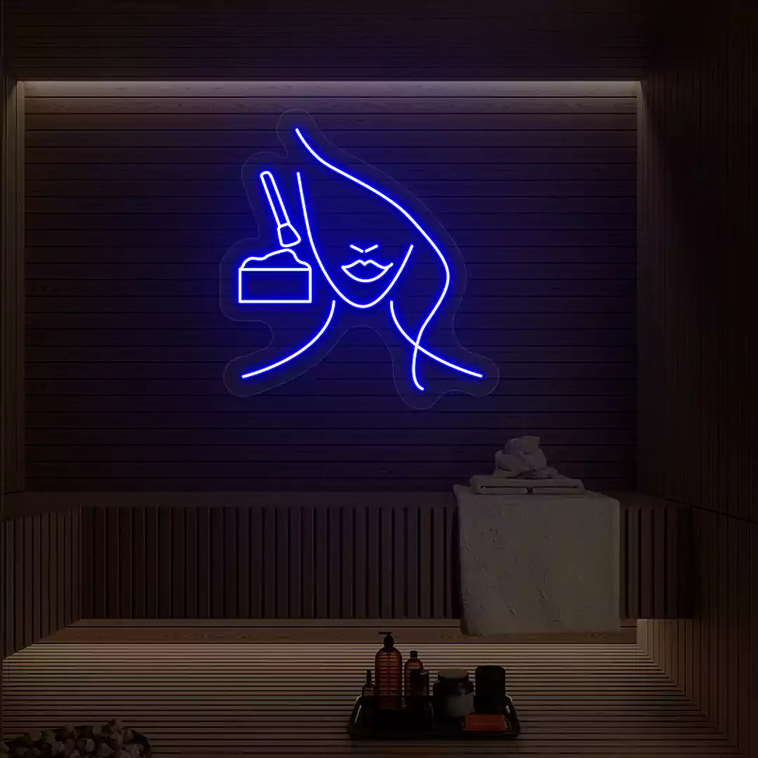 Blue Facial Retreat neon sign glowing on a wooden wall