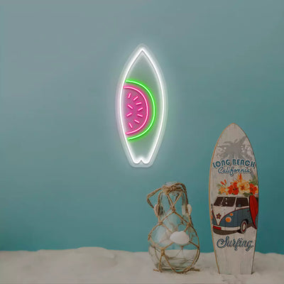 pink green and white watermelon surfboard neon sign mounted on a wall