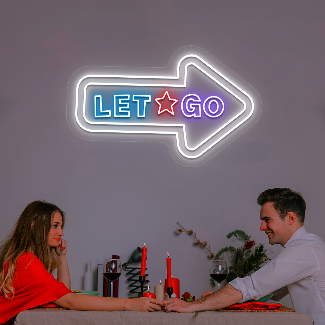 white let go arrow vintage neon sign mounted on a wall