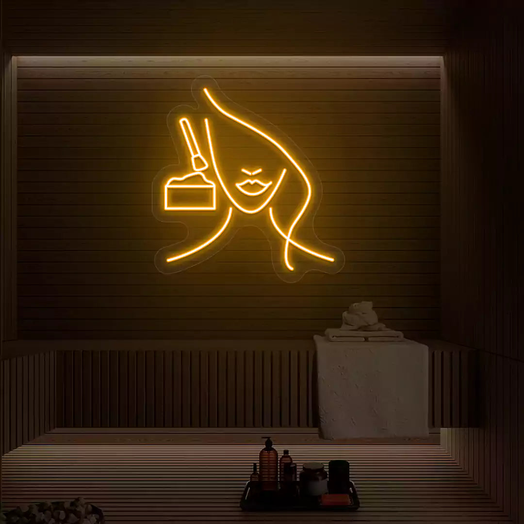 Orange Facial Retreat neon sign glowing on a wooden wall