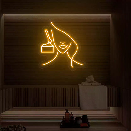 Orange Facial Retreat neon sign glowing on a wooden wall