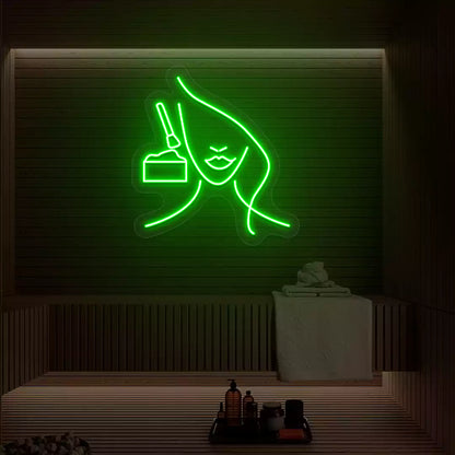 Green Facial Retreat neon sign glowing on a wooden wall