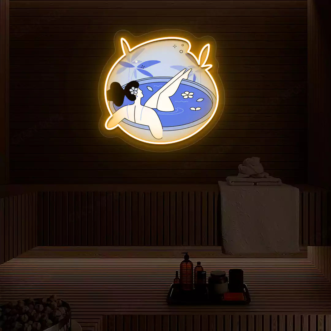 Blue Blossom Bath Neon Artwork lighting up in orange color on a wooden spa wall