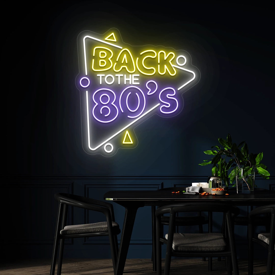 yellow purple and white back to the 80s vintage neon sign mounted on a wall