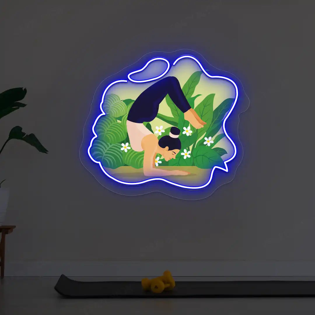Vrischikasana Garden Yoga Neon Artwork lighting up in blue color  in a yoga room