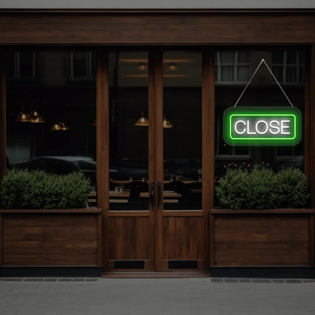 horizontal close neon sign glowing in green color on a window