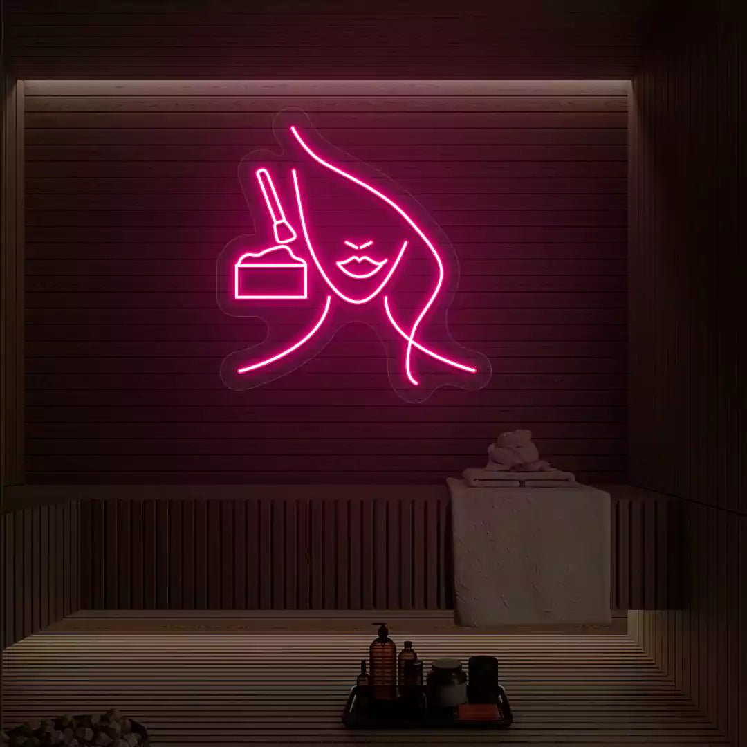 Pink Facial Retreat neon sign glowing on a wooden wall