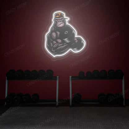white gorilla dumbbell lifting gym neon artwork mounted on a wall