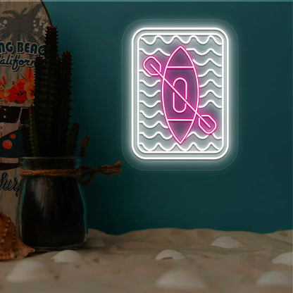 pink and white kayak ocean waves neon sign mounted on a wall