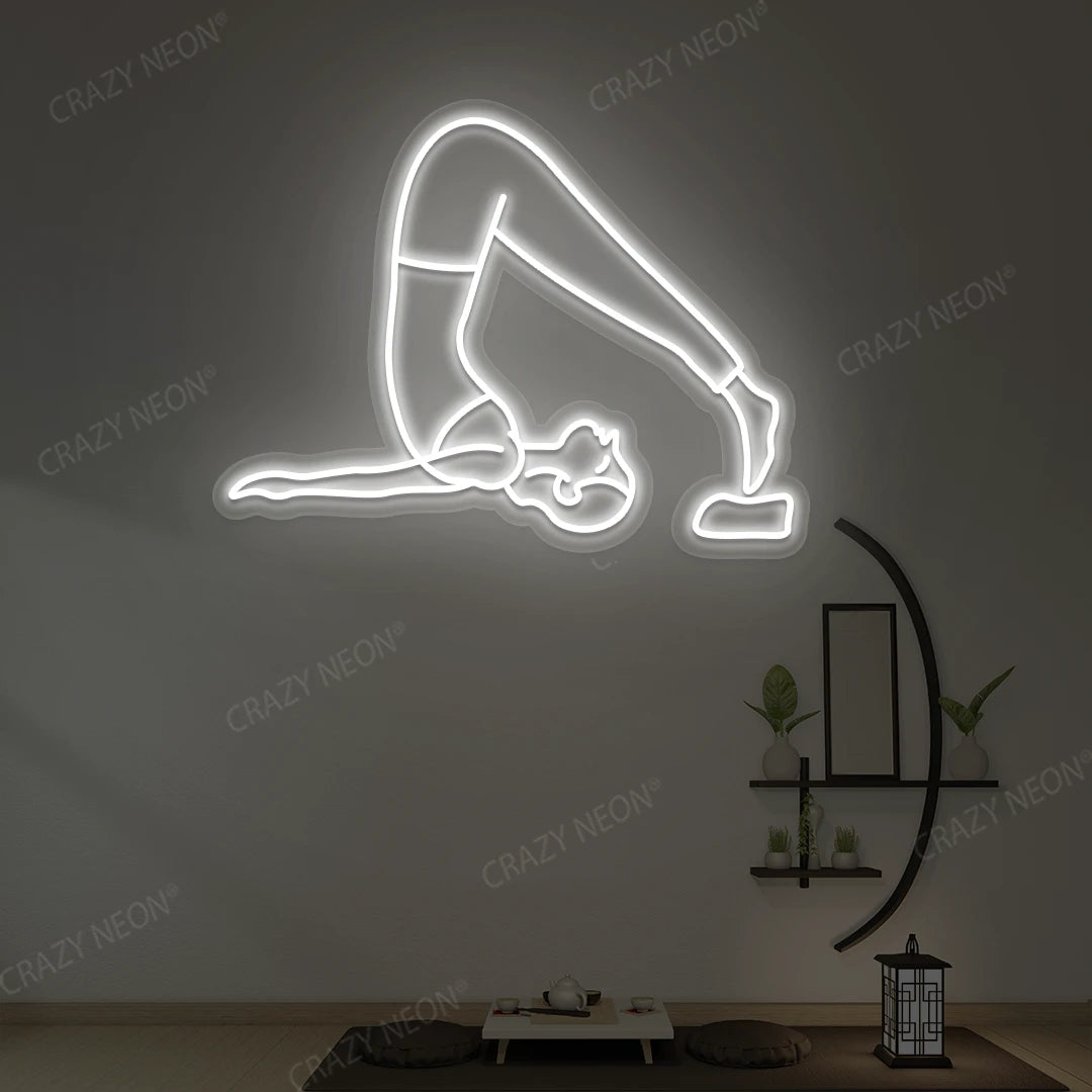 Halasana Yoga Neon Sign glowing in white color in a yoga room