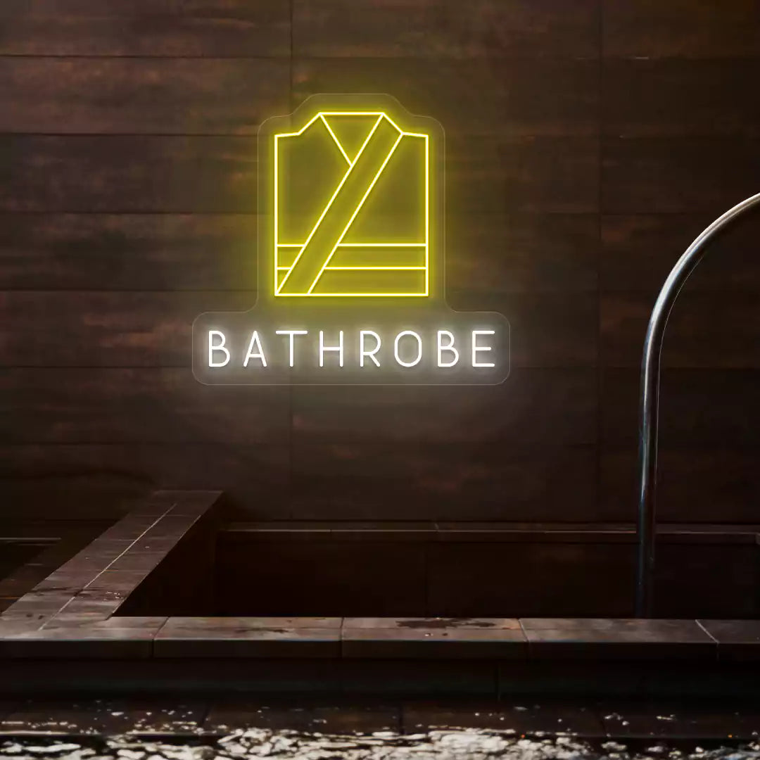 Golden Bathrobe neon sign in yellow and white colors glowing on a wooden wall