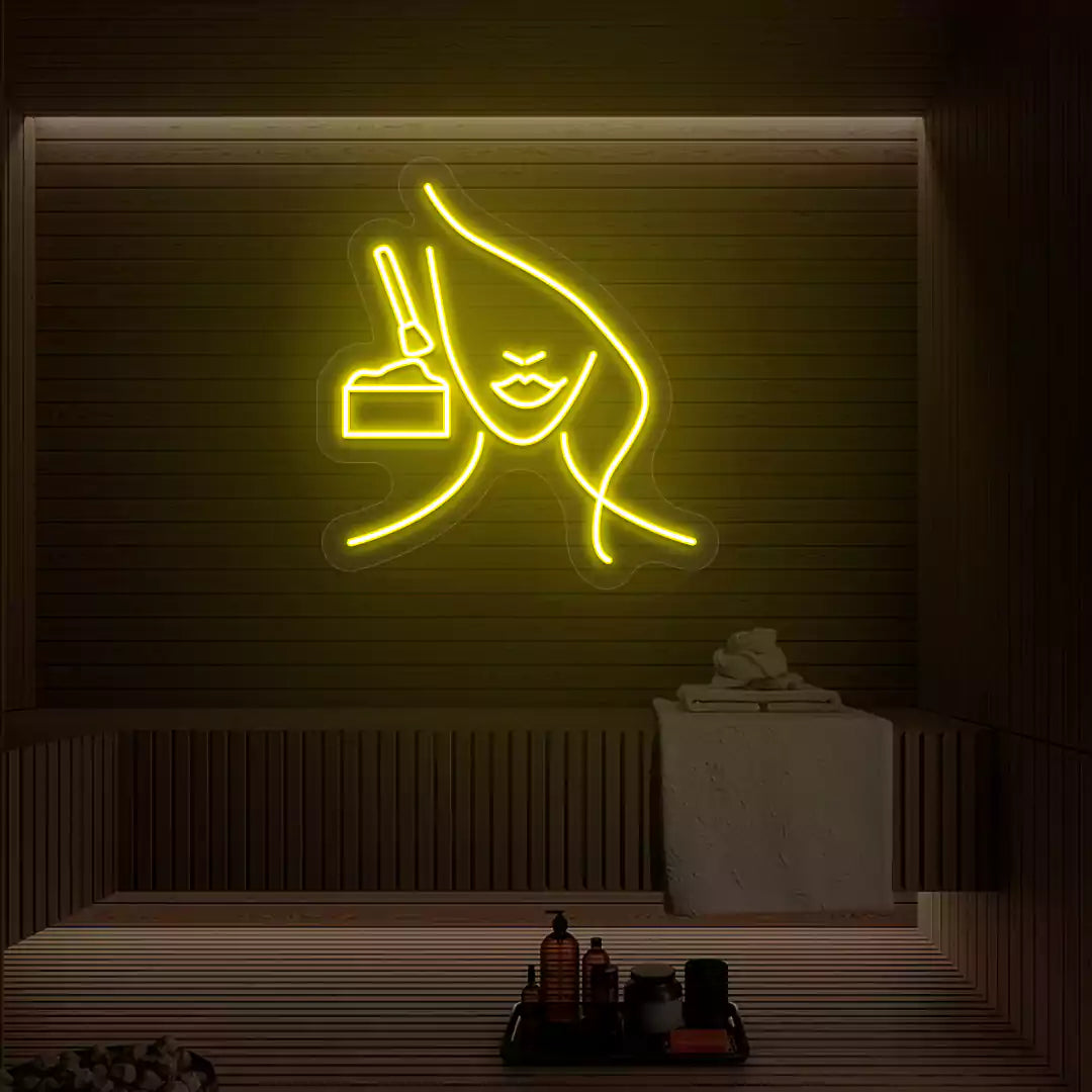 Yellow Facial Retreat neon sign glowing on a wooden wall