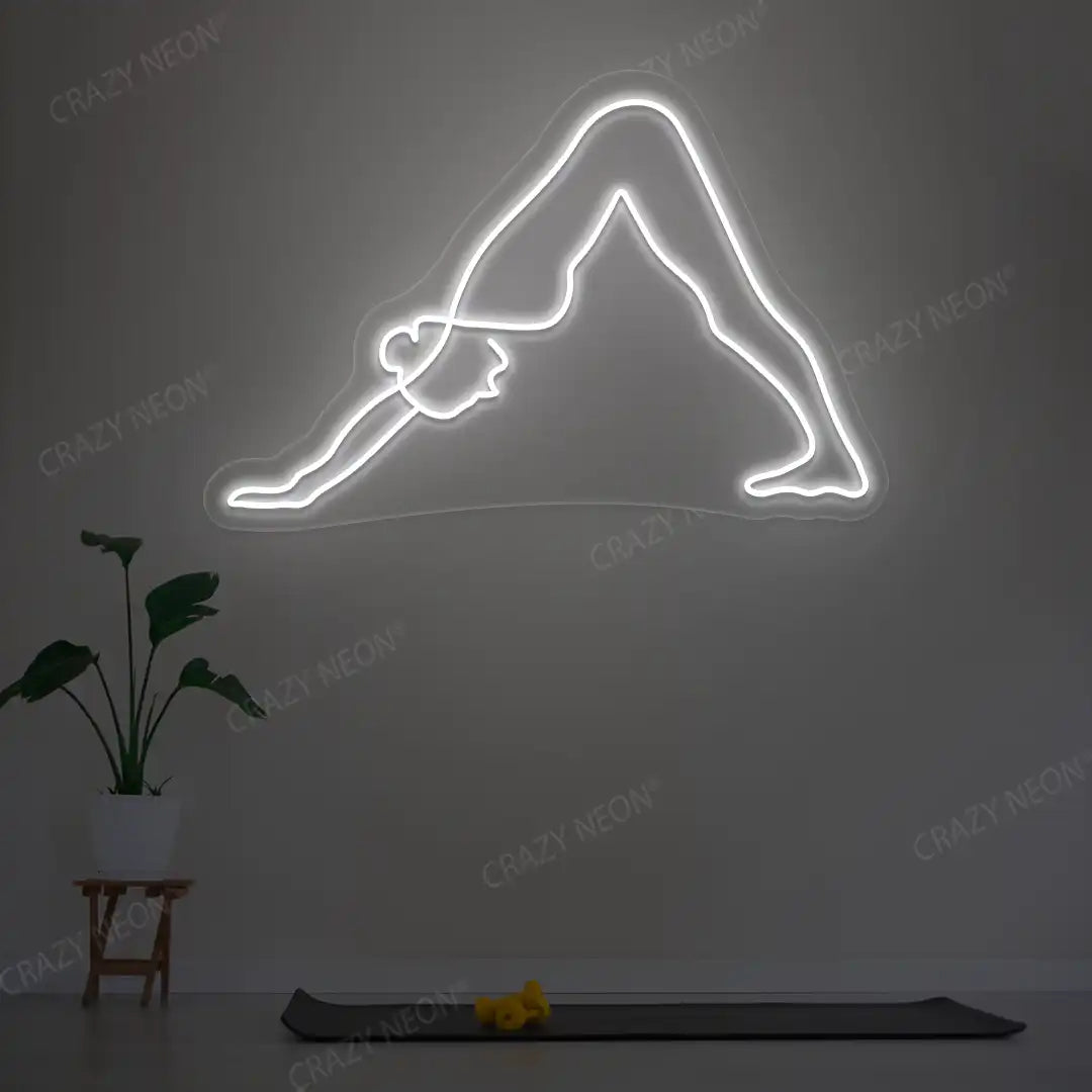 Adho Mukha Svanasana Yoga Neon Sign lighting up in white color in a yoga room