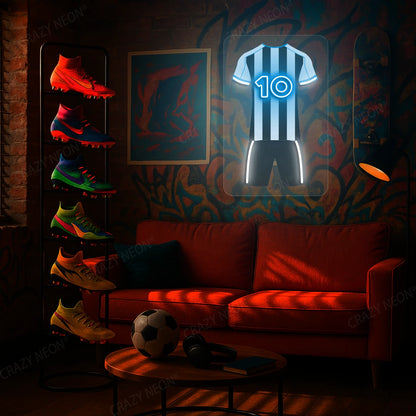 White and black striped football jersey neon artwork with number 10 glowing on a graffiti-decorated wall 