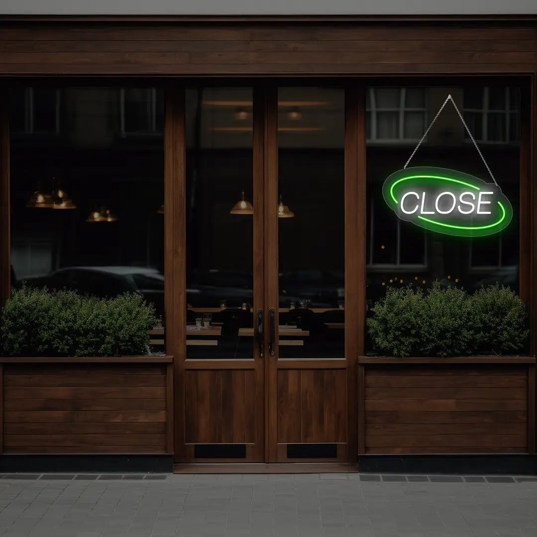 green semi oval close neon sign hanging on a window