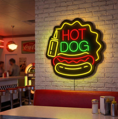 red green and yellow hot dog glow neon sign mounted on a wall