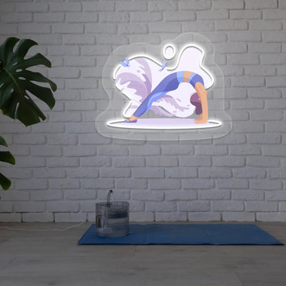 Urdhva Dhanurasana Yoga Neon Artwork lighting up in white color in a yoga room