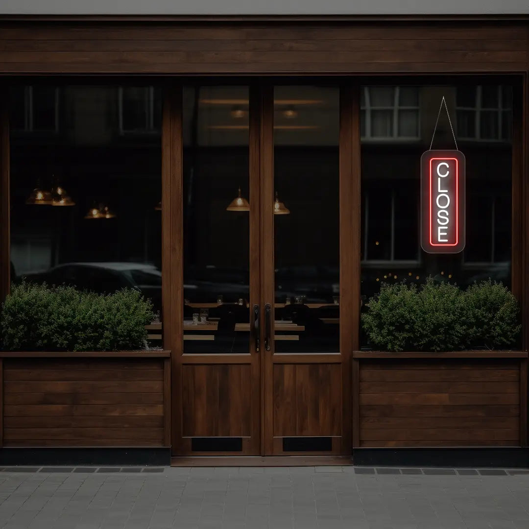 red vertical close neon sign hanging on a window