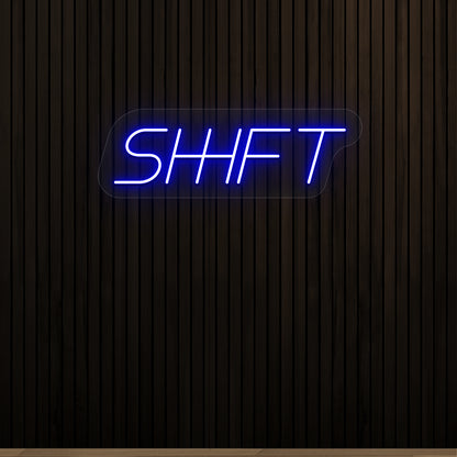 blue shift vintage neon sign mounted on a wall