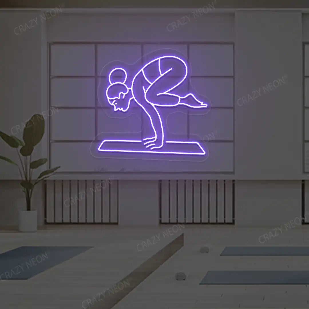 Bakasana Yoga Neon Sign lighting up in purple color in a yoga room