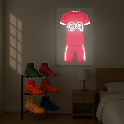 Red football jersey neon artwork with number 09 glowing on a wooden wall