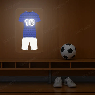 Blue football jersey neon artwork with number 18 glowing on a wooden wall