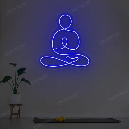 Swastikasana Yoga Neon Sign lighting up in blue color in a yoga room