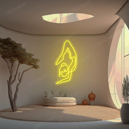 Purna Vrishchikasana Yoga Neon Sign glowing in yellow color in a yoga room