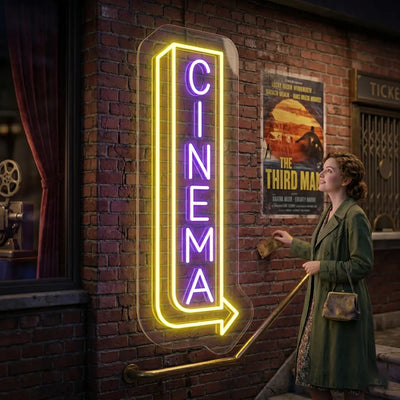 purple and yellow midnight cinema vintage neon sign mounted on a wall