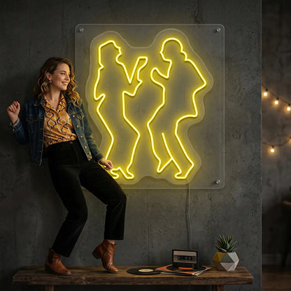 yellow twist dancing duet vintage neon sign mounted on a wall
