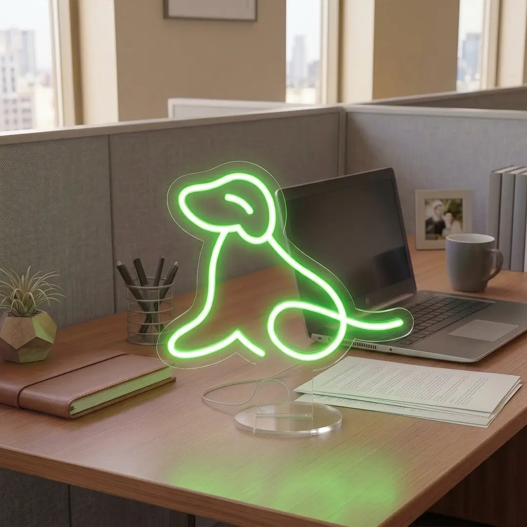 Green Dog Neon lamp on a modern office desk beside a laptop, notebook, and coffee mug, creating a warm and creative workspace atmosphere.