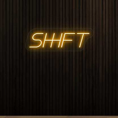 orange shift vintage neon sign mounted on a wall