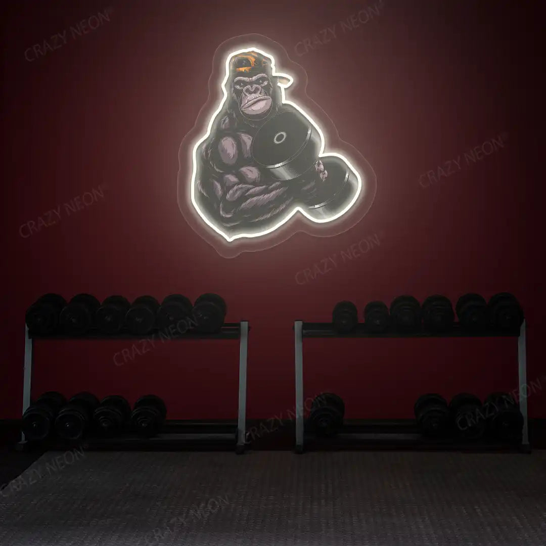 warm white gorilla dumbbell lifting gym neon artwork mounted on a wall