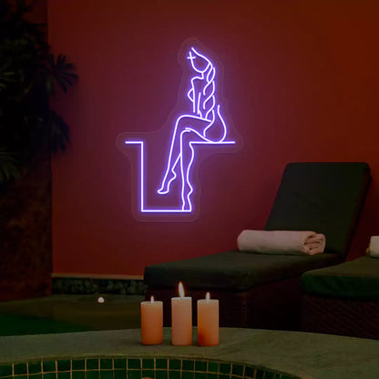 Purple Tranquil Lounge Spa neon sign glowing on a terracotta wall