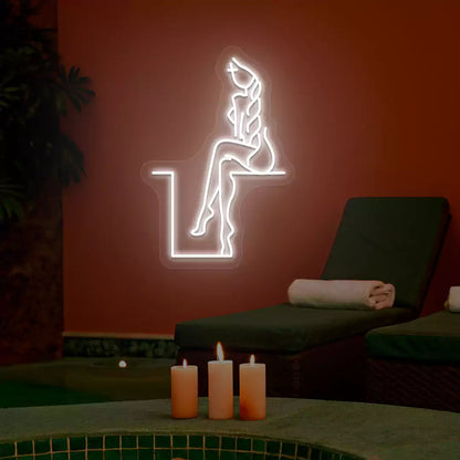 White Tranquil Lounge Spa neon sign glowing on a terracotta wall