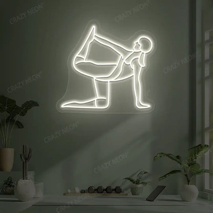 Ardha Dhanurasana Yoga Neon Sign glowing in warm white color in a yoga room
