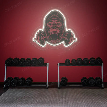 warm white gorilla barbell gym neon artwork mounted on a wall