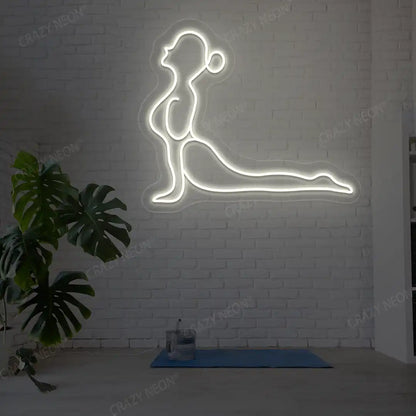 Bhujangasana Yoga Neon Sign glowing in warm white color in a yoga room