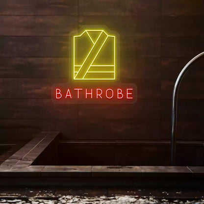 Golden Bathrobe neon sign in yellow and red colors glowing on a wooden wall